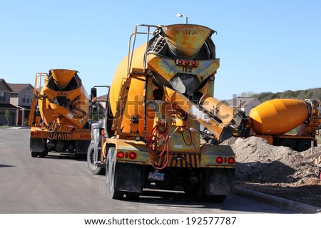 SAN ANTONIO, TX - OCTOBER 21, 2011 : Concrete mixing trucks create a traffic jam in a residential street as new home construction picks up
