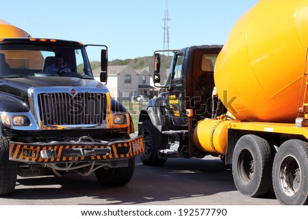 SAN ANTONIO, TX - OCTOBER 21, 2011 : Concrete mixing trucks create a traffic jam in a residential street as new home construction picks up