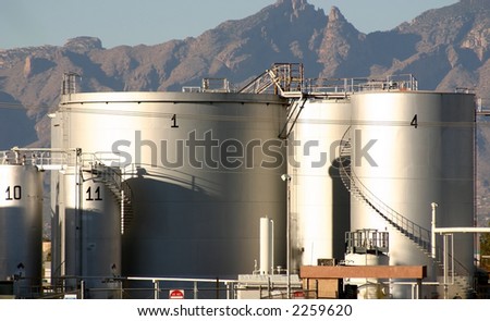 Tank farm for petroleum products in Tucson Arizona showing tanks access stairs articulated stars to the floating tank tops with the Catalina mountain range in the background