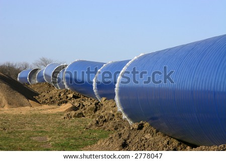 Sections of blue steel and concrete water conduit prior to bury