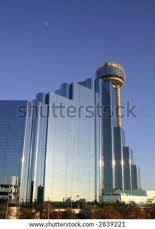 Dallas skyline and moon against blue sky at sunset