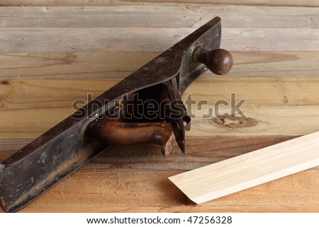 Antique wood planer on a weather wooden plank deck with a piece of finished molding