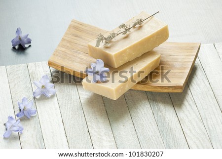 soaps balance and flowers on wooden table