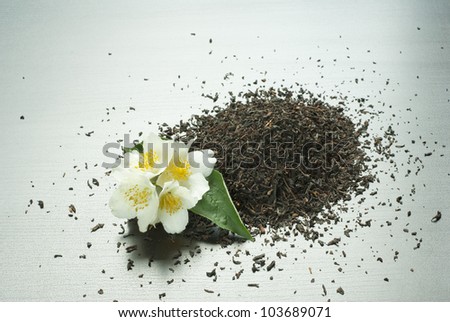 jasmine tea with jasmine flowers on black wooden table