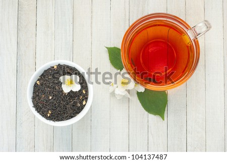 jasmine tea with jasmine flowers on wooden background