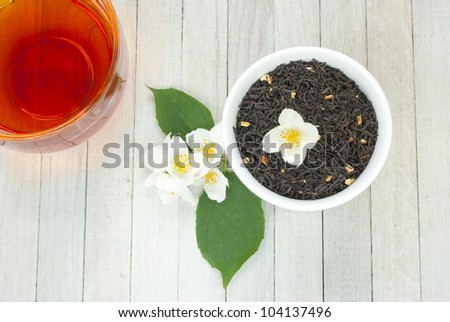 jasmine tea with jasmine flowers on wooden background
