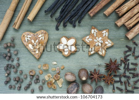 gingerbread figurines and dessert spices, wooden table background
