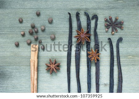 spices for desserts, cinnamon stick, vanilla beans and star anises on wooden table