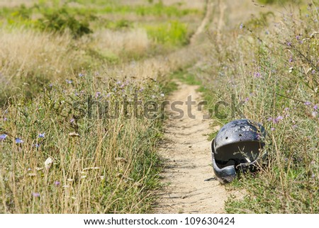 broken safety helmet, countryside road after motorbike rally