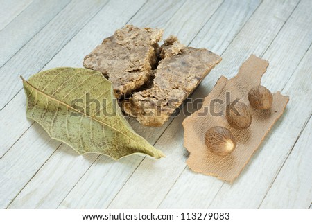 handmade african black soap and ingredients, shea butter nuts, dried leaves