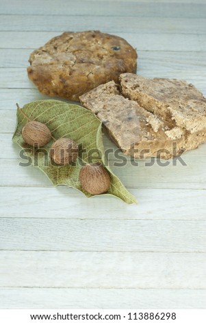 handmade african black soap and ingredients, shea butter nuts, leaf