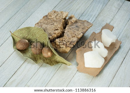 handmade african black soap and ingredients, shea butter nuts, leaf and white shea butter