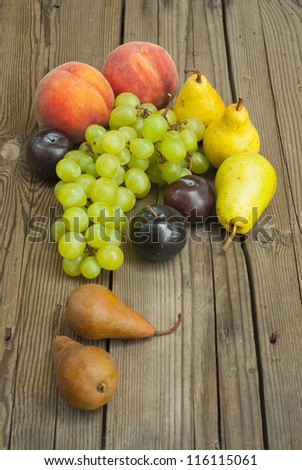 autumnal fruit still life on rustic wooden table background