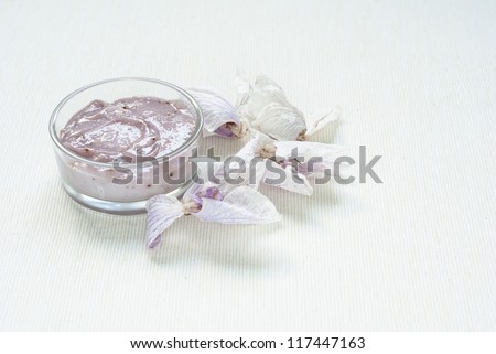 facial cream and dried orchids