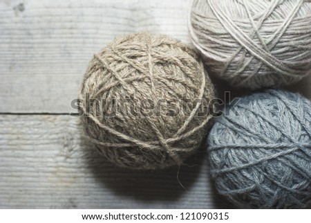 balls of wool on wooden background