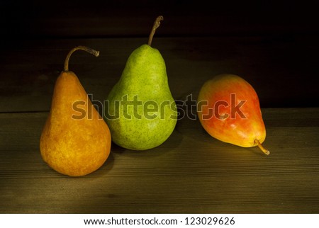 three pears, rustic wooden table