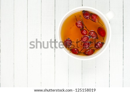 rose hip tea, white wood table, top view