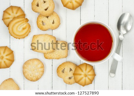afternoon tea and butter cookies on white wood table background, top view