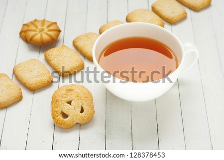 afternoon tea and butter cookies on white wood table background