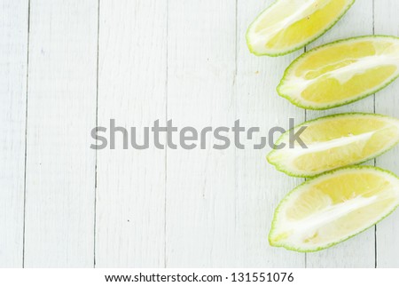 slices of lime on white wood  table directly above