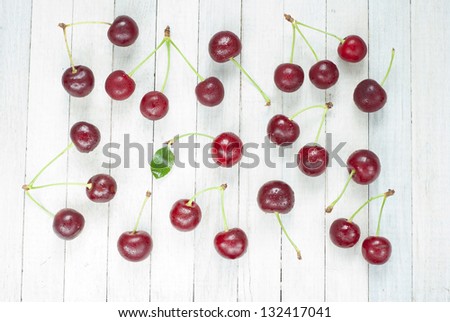 sour cherries on white wooden table, directly above