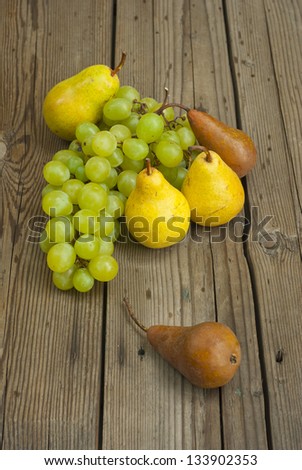 autumnal fruit still life on rustic wooden table background