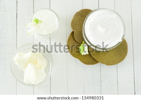 organic moisturizer creme on white wood table directly above