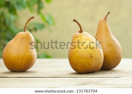 fresh pears on old wooden table