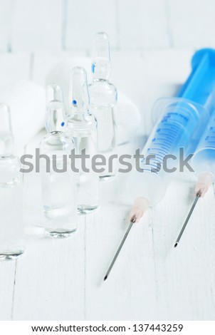 hypodermic needles and ampules, white background