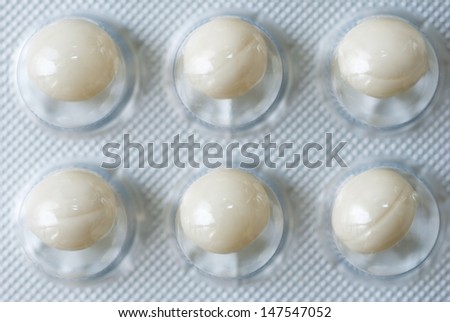 vitamin pills on white tablet