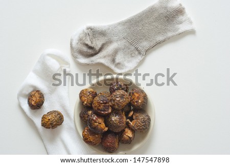 soap nuts natural detergent with dirty and clean baby socks