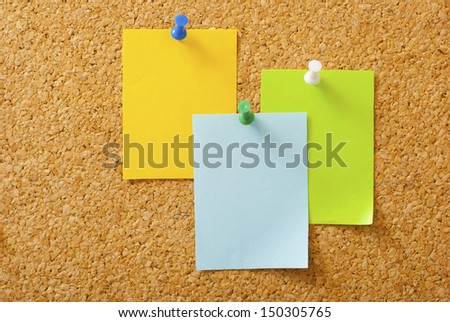 empty post its with pins on memo board