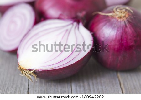 half cut spanish onions on old wood table