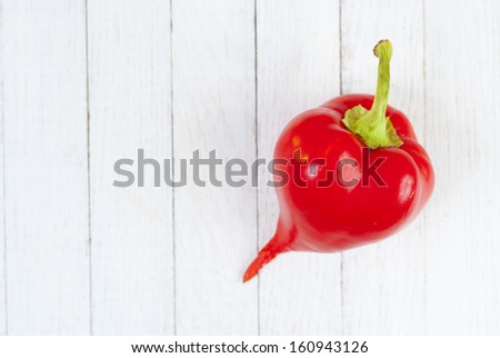 red pepper fruit on white wood table