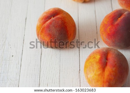 ripe peaches on white wood table