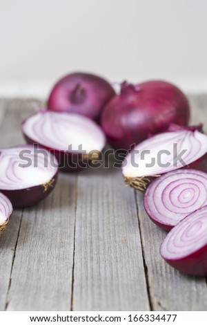 half cut spanish onions on old wood table