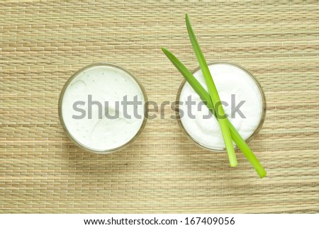 cosmetics cream and oil on bamboo background, directly above