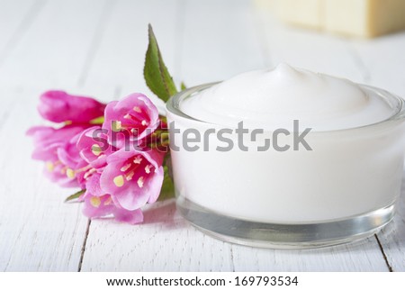 acne cream, on white wood table