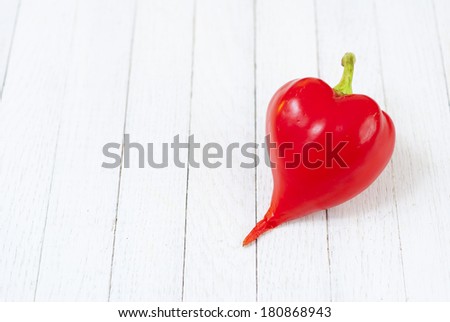 red pepper fruit on white wood table