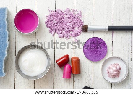 makeup accessories on white wooden