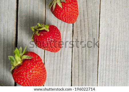 strawberry fruits on old wooden