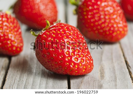 strawberry fruits on old wooden
