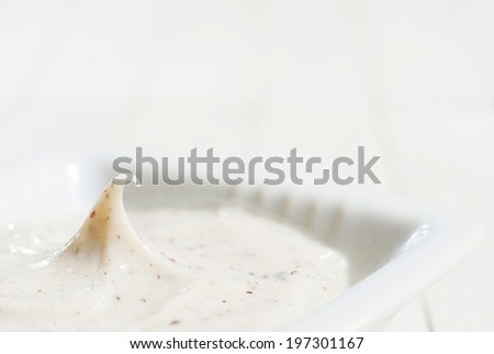 facial cleanser on white wooden background