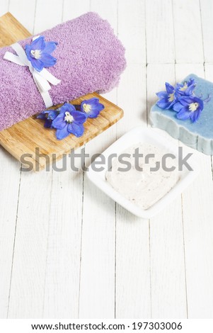 facial cleanser and handmade organic soap wood background