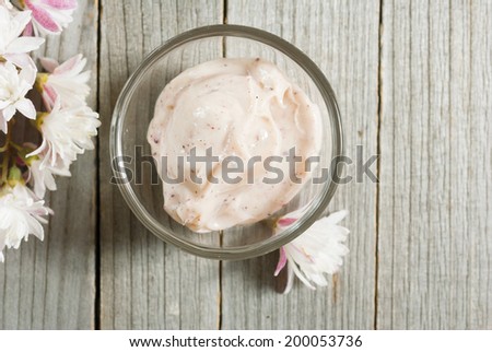 cosmetic cream  and flowers on old wood background