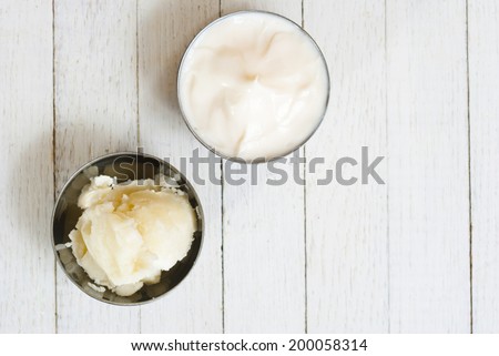moisturizer and shea butter on white wooden