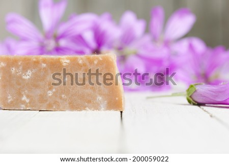 soap and flowers on wooden