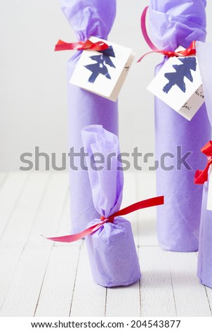 purple paper wrapped gift bottles