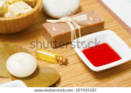 natural moisturizer, bath salt, soaps, dried st johns wort and red oil from hypericum perforatum on bamboo background