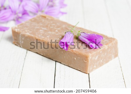 soap and flowers on bright wooden